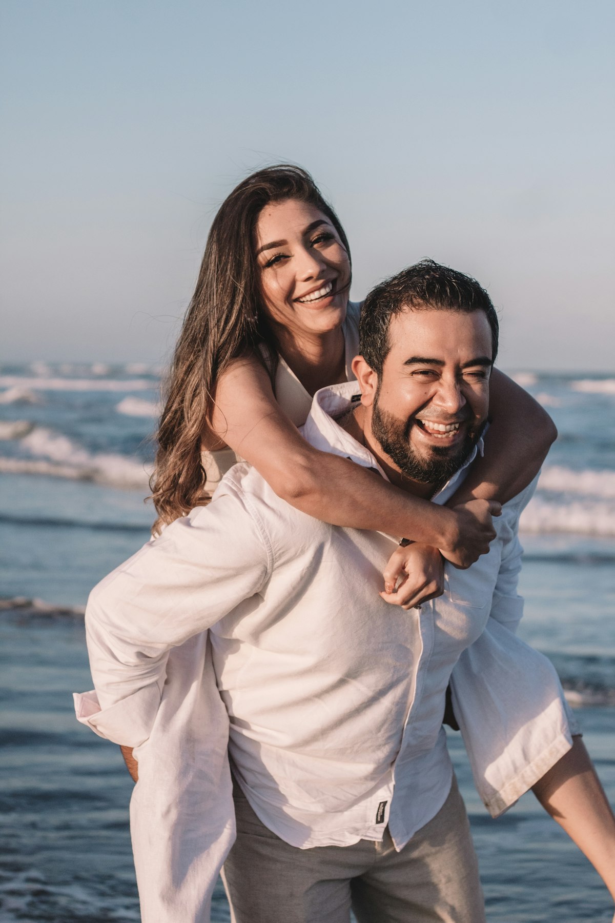 Couple laughing together by the sea